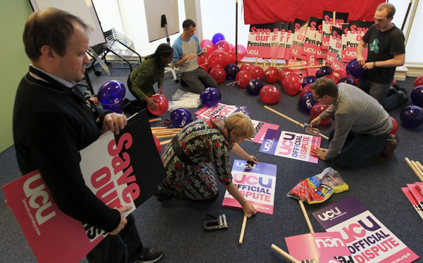 Staff at the University and College Union prepare placards for the November 30 public sector strike, at their offices in Camden, north London November 28, 2011. Britain faces its biggest strike in 30 years on Wednesday, a one-day walkout over public-