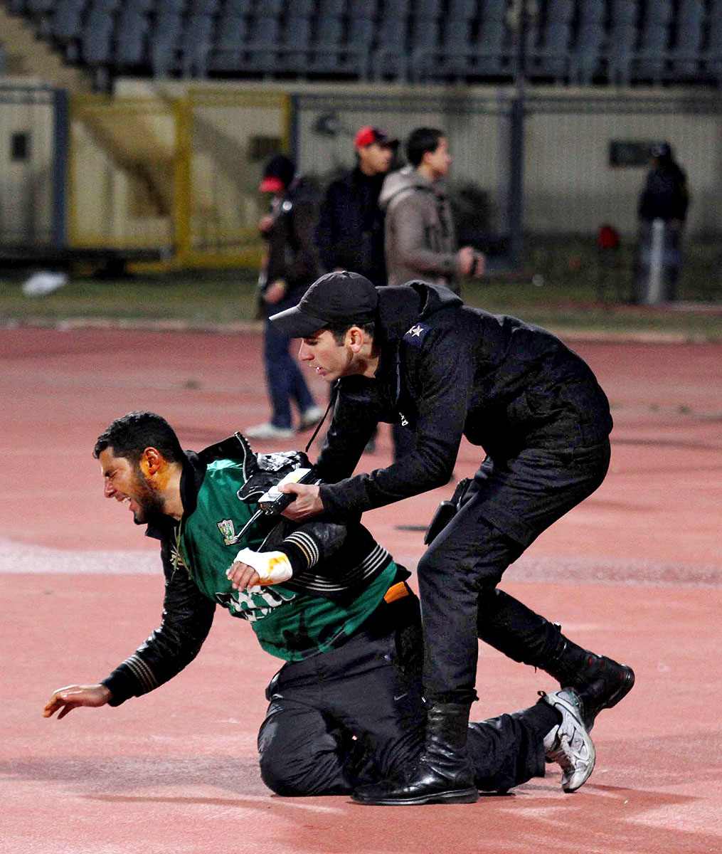 Sebesült futballhuligánt tartóztat le egy rendőr az egyiptomi stadionban