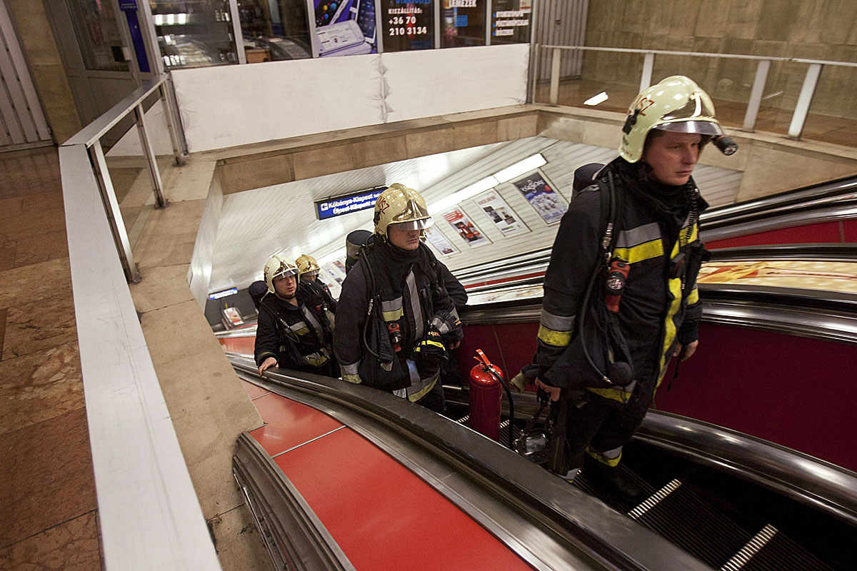 Tűzoltók jönnek fel a mozgólépcsőn, a metró Deák téri állomásán, miután füst árasztotta el az alagutat