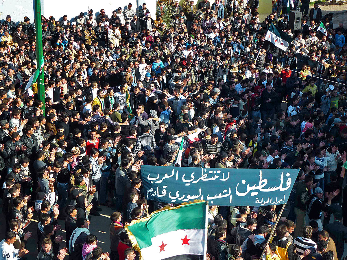 Demonstrators protest against Syria's President Bashar al-Assad in the town of Hula near the city of Homs February 3, 2012. The banner reads, 