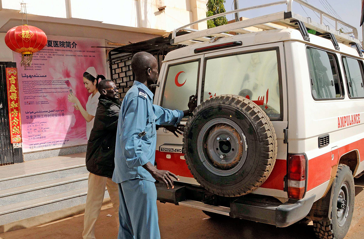Police close the door of an ambulance carrying the body of a Chinese worker killed during a kidnapping, after he was handed over to Chinese Embassy representatives by a Sudanese Red Crescent representative and a Sudanese Foreign Ministry official at 
