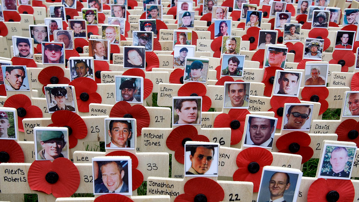 Crosses bearing the faces of British soldiers killed in Afghanistan, are pictured in the Field of Remembrance at Westminster Abbey in London November 5, 2009.    REUTERS/Alastair Grant/Pool    (BRITAIN MILITARY ANNIVERSARY IMAGES OF THE DAY)