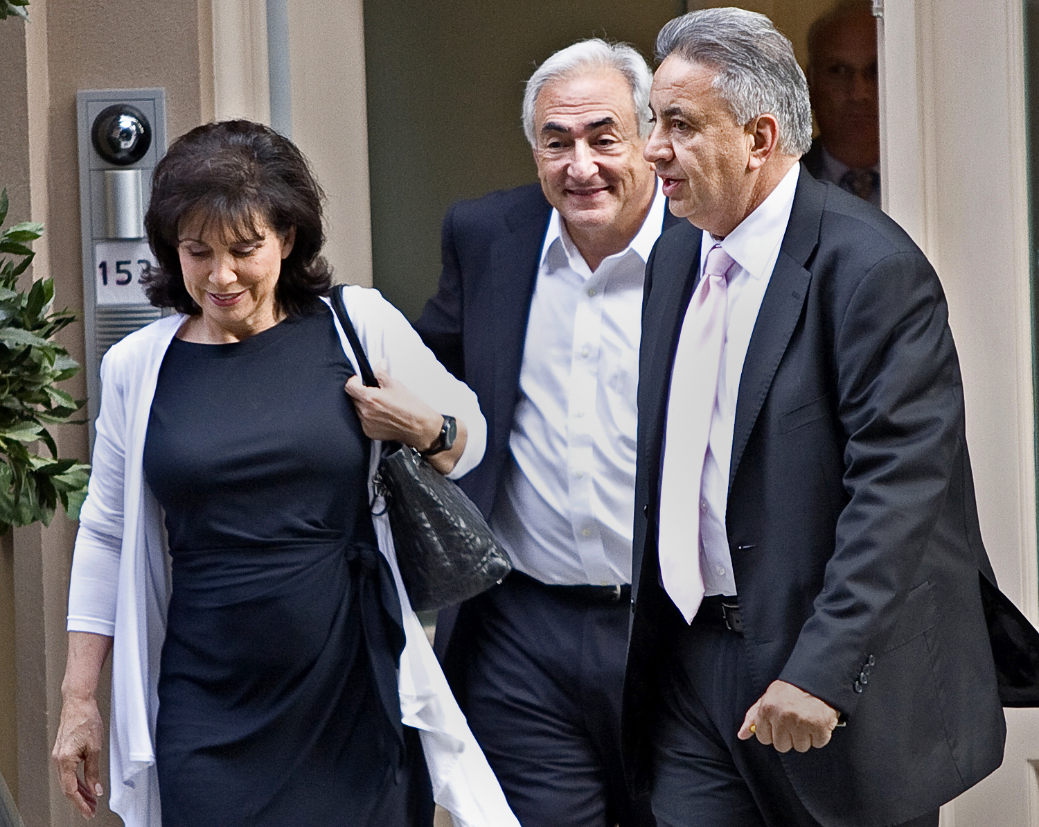Strauss-Kahn (középen) felesége, Anne Sinclair oldalán