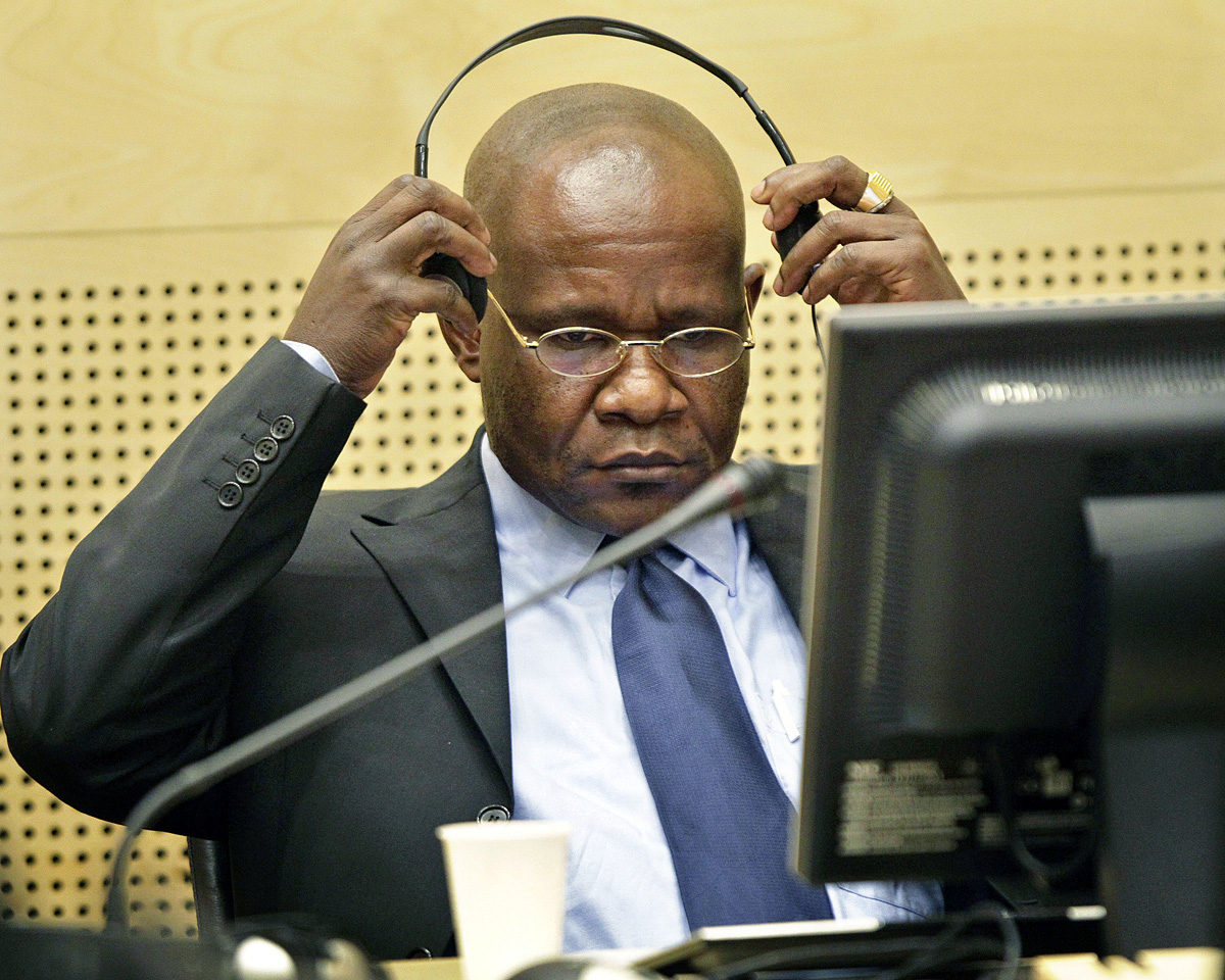 Congolese warlord Mathieu Ngudjolo Chui puts on his headset in the courtroom of the International Criminal Court in The Hague November 24, 2009. The world's first permanent war crimes court opens its second trial on Tuesday when two Congolese warlord