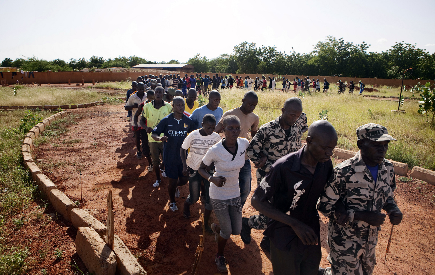 People run during a training session at the FLN movement (North Liberation Forces) camp in Sevare September 24, 2012. The FLN is a part of a militia which trains youths from all over the country and operates in government-controlled areas run by curr