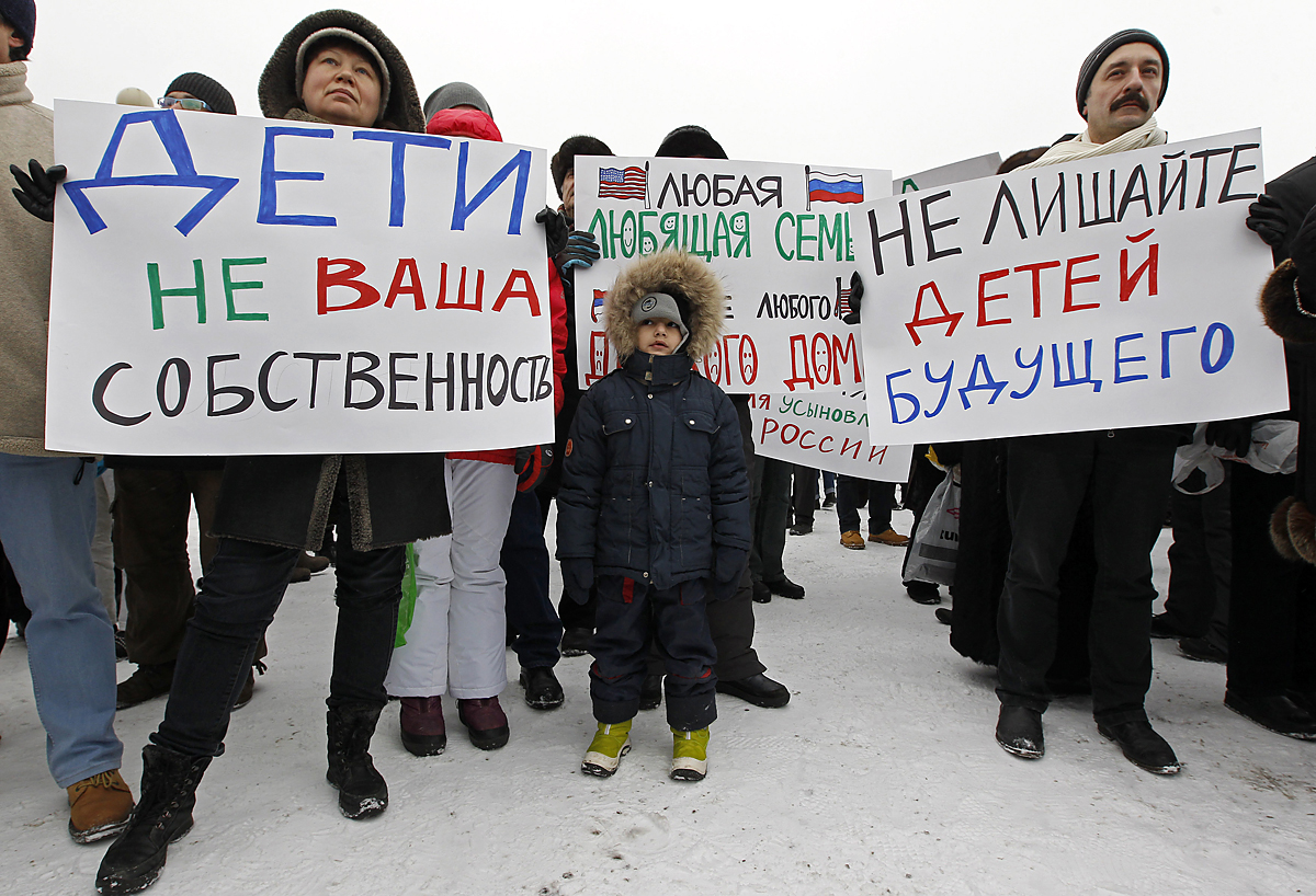 People take part in a rally to protest against the law, that bans Americans from adopting Russian children, in St. Petersburg, January 13, 2013. Thousands of demonstrators gathered for a march in Moscow on Sunday to protest against a ban on Americans