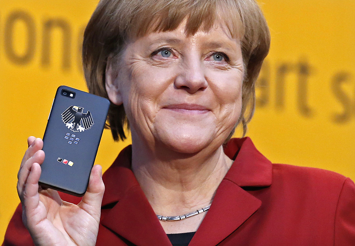 German Chancellor Angela Merkel holds a BlackBerry Z10 smartphone featuring high security Secusite software, used for governmental communication, at the booth of Secusmart during her opening tour at the CeBit computer fair in Hanover March, 5, 2013. 