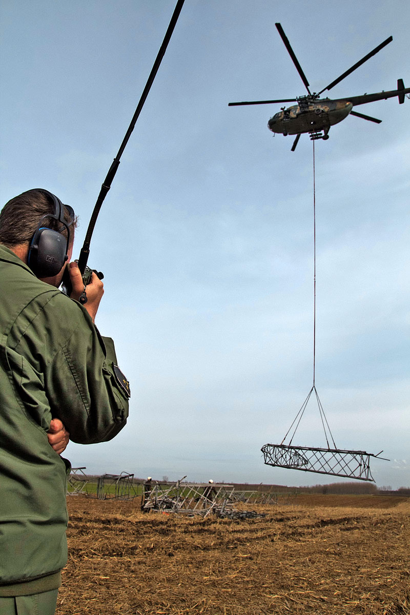 A helikopter egy kidőlt villanyoszlop darabját emeli föl Ibrány határában