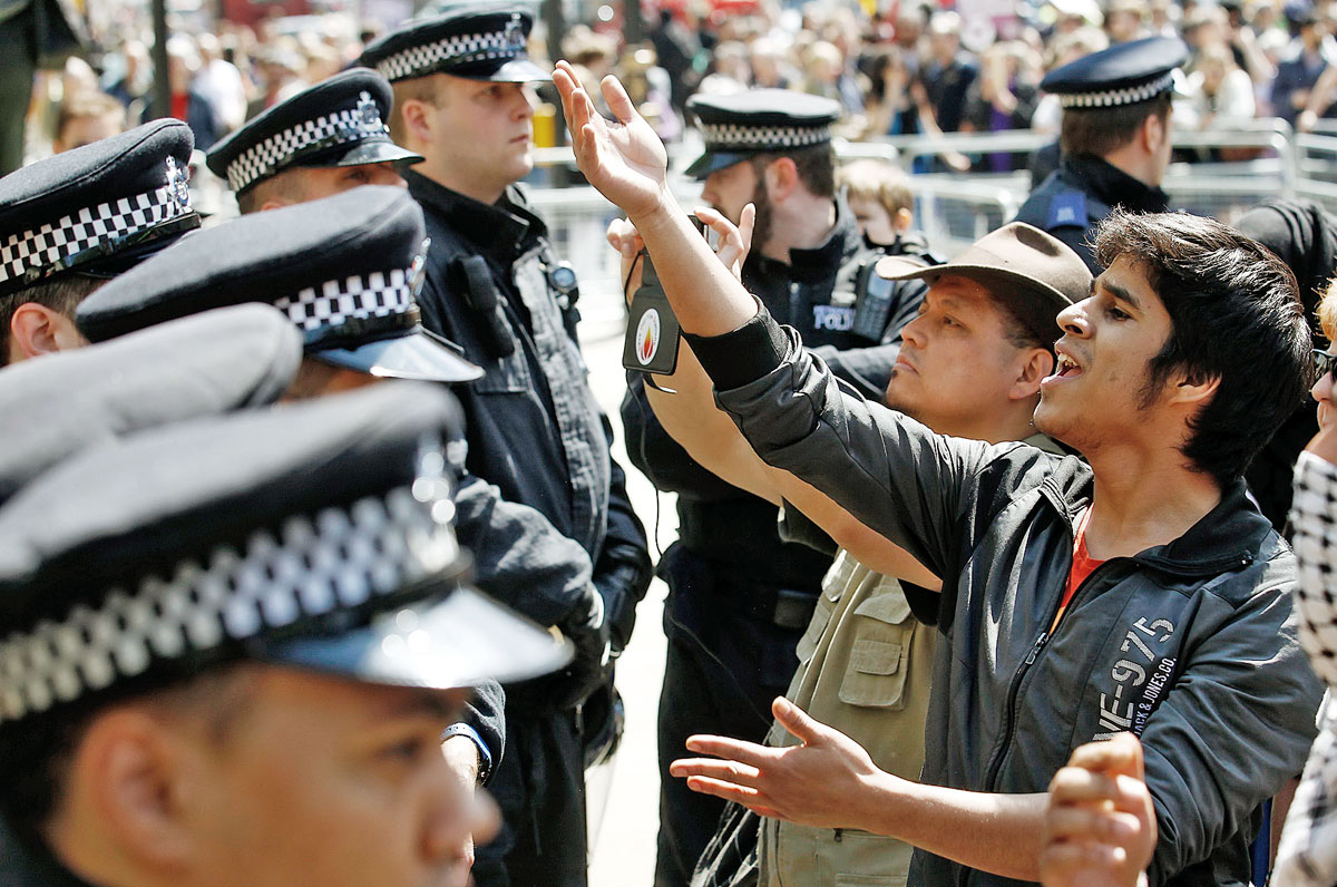 Antifasiszta tiltakozók a rendőrsorfalon kiabálnak át az Angol Védelmi Liga tüntetőire a londoni Downing Streeten