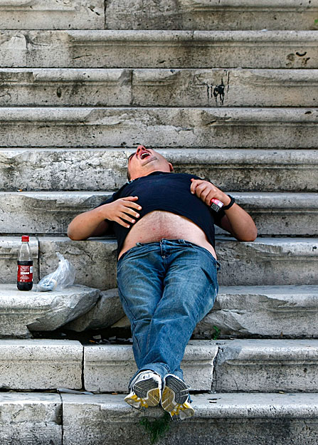 A man yawns while taking an afternoon nap on the steps of the ruins of the Royal Opera House in Valletta October 6, 2008.  REUTERS/Darrin Zammit Lupi (MALTA).  MALTA OUT. NO COMMERCIAL OR EDITORIAL SALES IN MALTA.