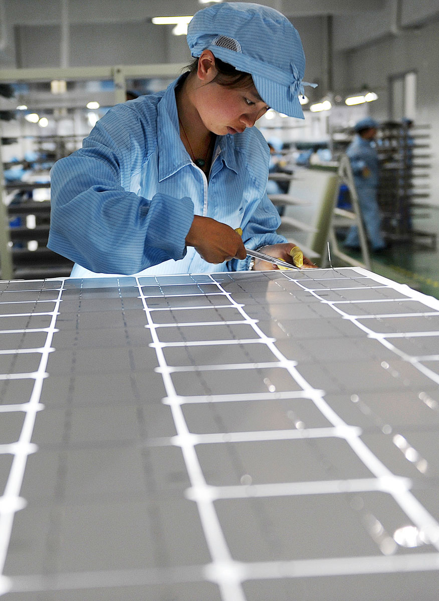 Gyártósoron dolgozik egy munkás egy kínai napelemgyárban