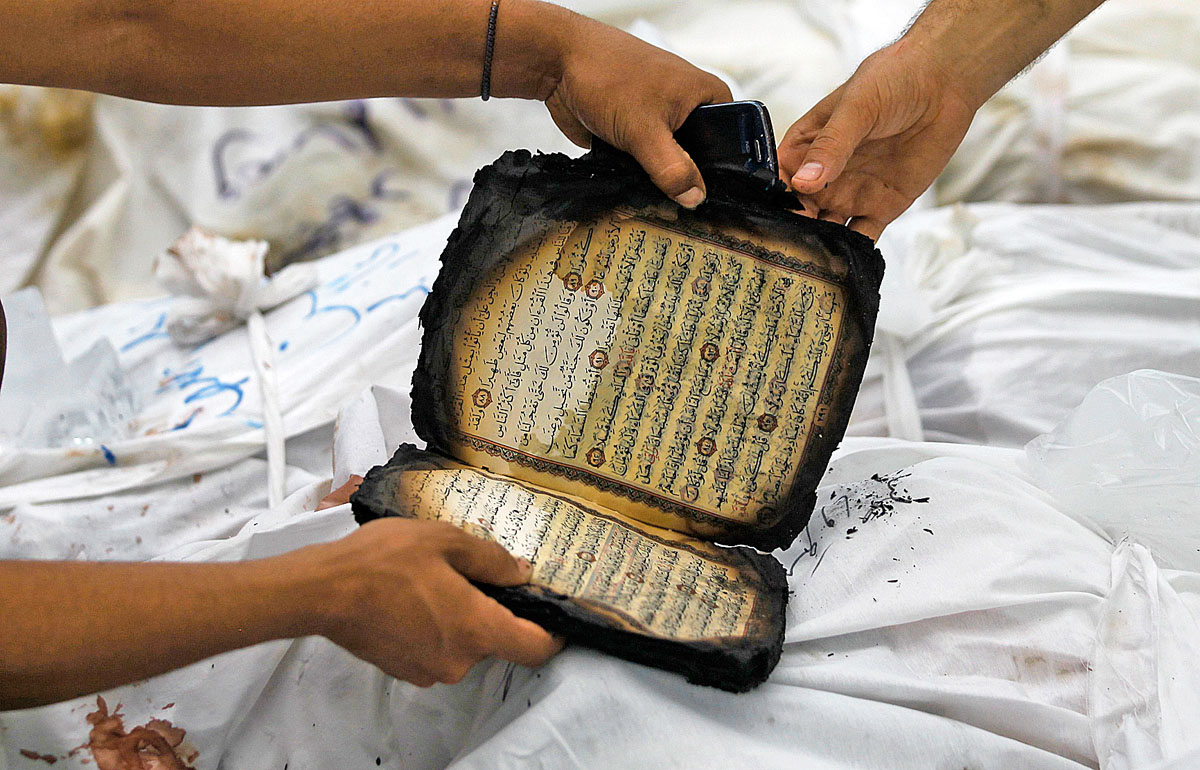 Megégett Koránt néznek az áldozatok holtteste felett Kairóban