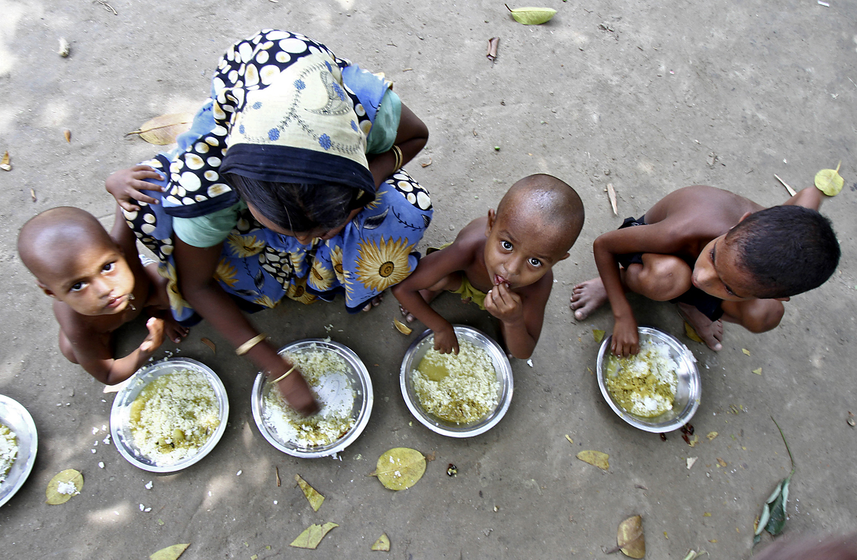 Villagers from Muslim communities affected by ethnic riots eat their community lunch inside a relief camp near Bilasipara town in the northeastern Indian state of Assam August 8, 2012. Violence between the Bodo tribespeople and Muslim communities in 
