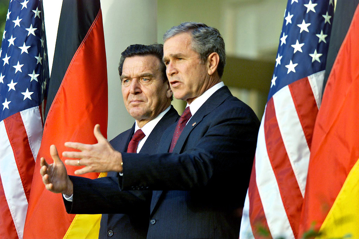 German Chancellor Gerhard Schroeder (L) looks on as U.S. President
George W. Bush speaks to the media in the Rose Garden of the White
House following their meeting October 9, 2001. Bush and Schroeder
discussed a number of areas of cooperation in t