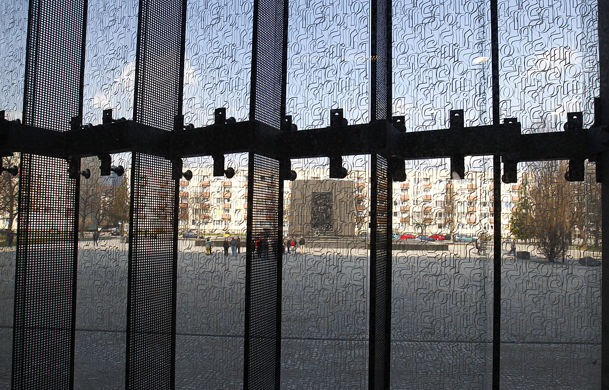 The Monument to the Ghetto Heroes is pictured through a window of the newly constructed building of the Museum of the History of the Polish Jews designed by architect Rainer Mahlamaki and located in the former Warsaw's Ghetto, April 17, 2013. The off
