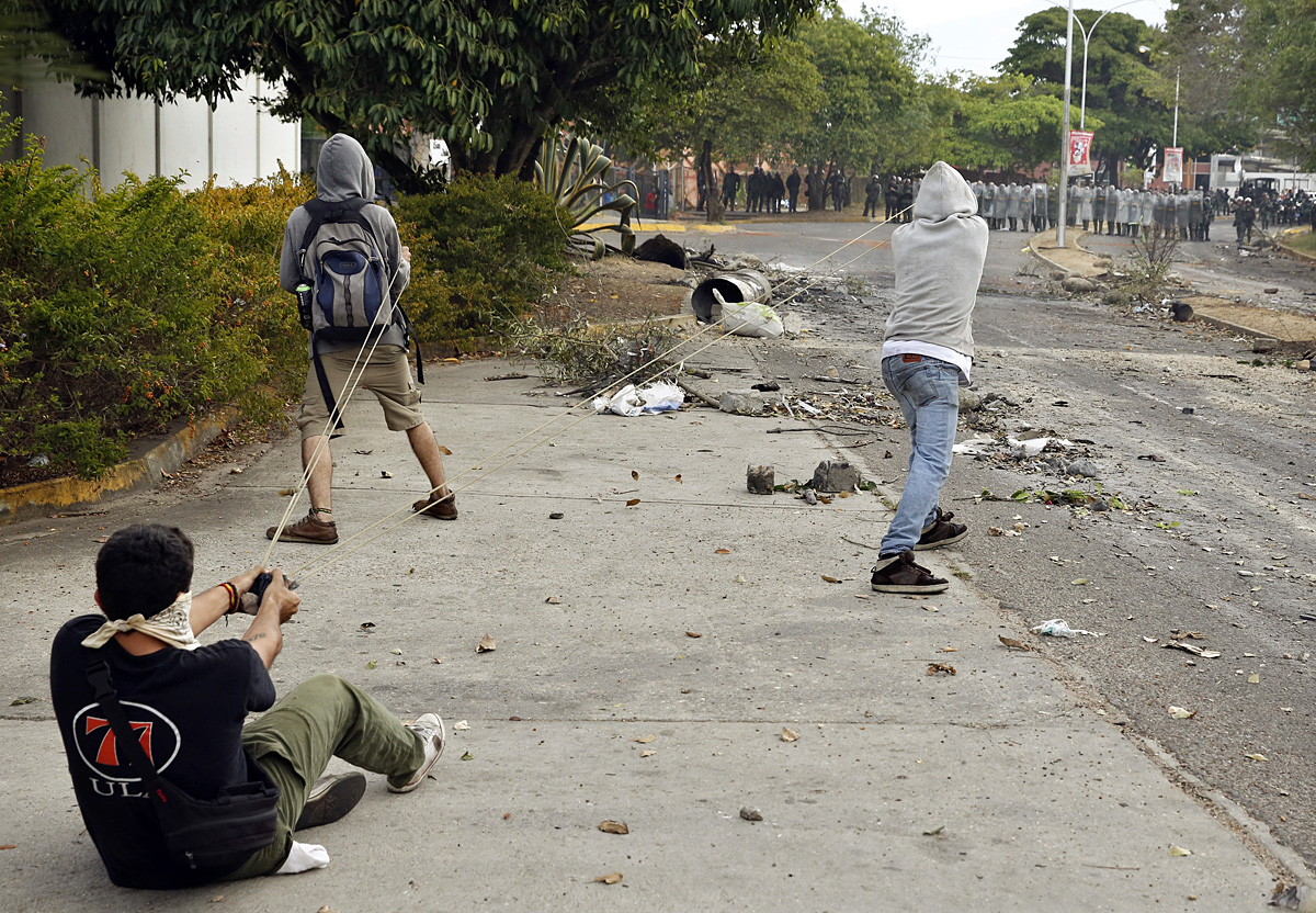 Demonstrators use a slingshot against the National Guard during a protest against Venezuelan President Nicolas Maduro's government in San Cristobal, about 410 miles (660 km) southwest of Caracas, February 27, 2014. U.N. Secretary-General Ban Ki-moon 
