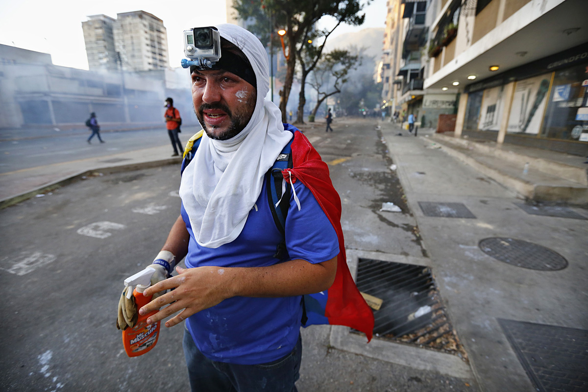 An anti-government protester, with a camera strapped to his forehead, stands during a rally in Caracas March 2, 2014. While many Venezuelans went to the beach to enjoy the Carnival holiday, thousands of anti-government demonstrators marched in the ca