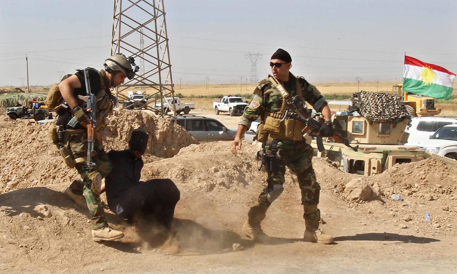 Pesmergák egy szunnita szélsőségessel júniusban. Pénz nincs rájuk, de a milliárdokból összehozott iraki reguláris hadsereg helyett inkább ők és a síita milíciák harcolnak az IS egységei ellen