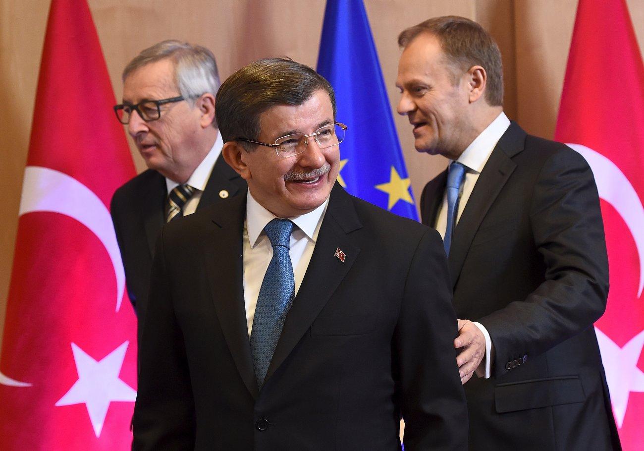 Juncker (b) és Tusk (j) terelgetik a török kormányfőt