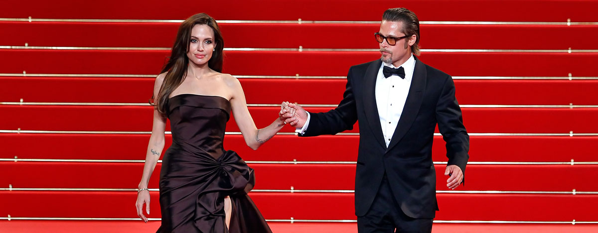 Cast member Brad Pitt (R) and actress Angelina Jolie (L) leave the festival palace after the screening of the film 