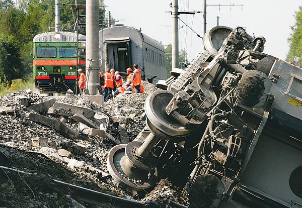 A sínrobbantás színhelyén, kisiklott, felborult vagonok között dolgoznak a mentők