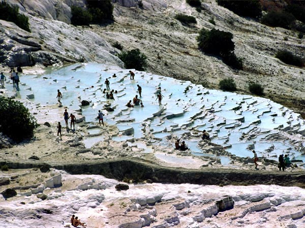 Turisták sokasága Pamukkale mésztufagátjain