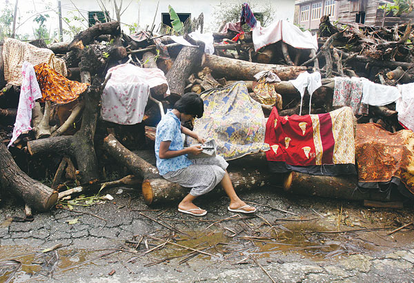 Yangon közelében egy elpusztult faluban szárítgatják holmijaikat az emberek