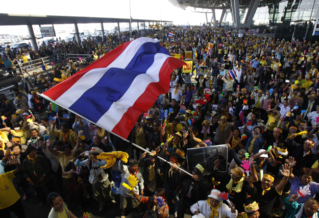 Anti-government protesters celebrate during a rally at Bangkok's Suvarnabhumi international airport December 2, 2008 after Thai court orders Prime Minister Somchai Wongsawat's ruling People Power Party (PPP) to be disbanded. Thai judges ordered Somch