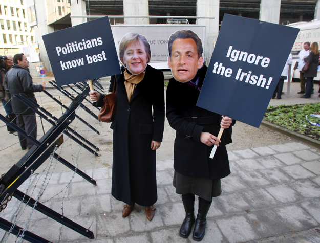 Angela Merkel és Nicolas Sarkozy képmását viselő nők tüntetnek Brüsszelben, mert szerintük az EU állam- és kormányfői semmibe akarják venni az ír népszavazás eredményét