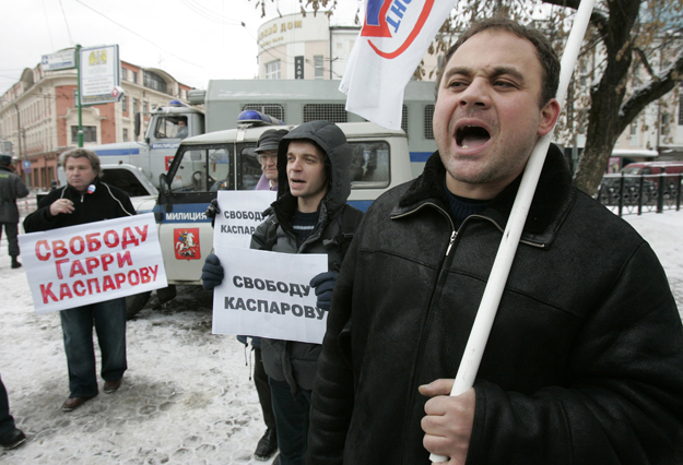 People hold banners and shout slogans during a protest in support of opposition leader Garry Kasparov in Moscow November 29, 2007