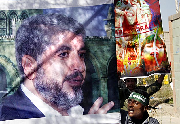 A student shouts anti-Israeli slogans as he holds a picture of Hamas leader Khaled Meshaal during a protest against Israel's offensive on the Gaza Strip, outside the United Nations office in Sanaa January 13, 2009. 