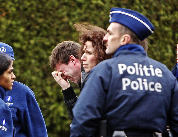 Parents react as they leave a building where families received assistance near the scene of a knife attack at a creche in Dendermonde January 23, 2009. An assailant killed two children and an adult in the knife attack in western Belgium on Friday, au