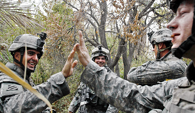 U.S. soldiers with Alpha Company, 1st Battalion, 30th Infantry Regiment, celebrate after finding a weapons cache during a search mission in the Sunni neighbourhood of Arab Jabour in south Baghdad October 19, 2007. 