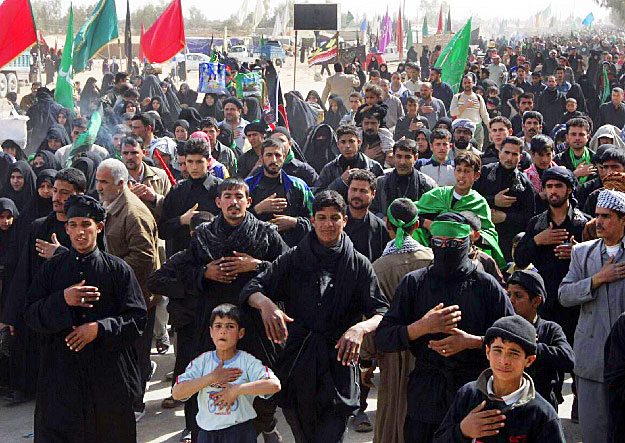 Shi'ite pilgrims beat their chests as they shout religious slogans while marching to the holy city of Kerbala to mark Arbain, in Najaf, 160km (100 miles) south of Baghdad, February 13, 2009. A female suicide bomber blew herself up in a crowd of Shi'i
