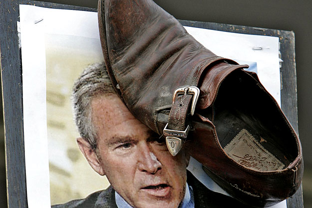 A protester displays a shoe stuck to a picture of U.S. President George W. Bush during a protest in Amman December 20, 2008. Protesters on Saturday showed their support for detained Iraqi journalist Muntazer al-Zaidi, who hurled his shoes at U.S. Pre