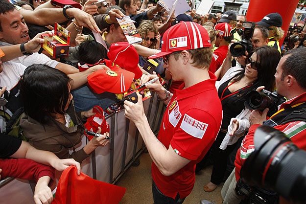 Ferrari Formula One driver Kimi Raikkonen of Finland signs autographs at an event for Ferrari fans ahead of the weekend's Australian F1 Grand Prix in Melbourne March 26, 2009. 
