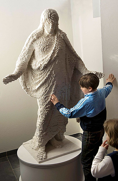 A boy examines a statue of Jesus Christ made entirely out of Lego bricks at a church at Vasteras April 12, 2009. The 1.8 metre (5.9ft) tall statue, a copy of Thorvaldsen's 