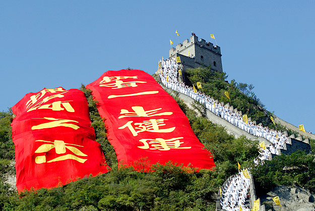 Chinese Tai Chi practitioners line the Great Wall to perform the ancient martial art September 28, 2003. More than 10,000 Tai Chi practitioners took part in the event on the outskirts of China's capital as part of a culture festival to promote the 20