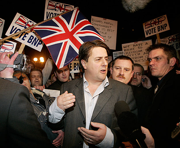 Griffin the leader of the far-right BNP speaks to the media as he leaves a police station in northern England after being arrested.  Nick Griffin (C) the leader of the far-right British National Party (BNP) is surrounded by supporters as he speaks to