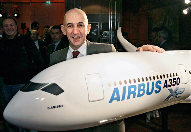 Airbus President and Chief Executive Louis Gallois poses with a model of the Airbus A 350 XWB before a news conference in Paris, December 4, 2006. Airbus said on Monday funding for its wide bodied A350 plane remained open and might include a capital 