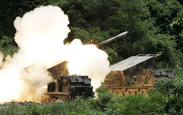 A South Korean Army Multiple Launch Rocket System (MLRS) fires during a military drill against possible attacks by North Korea, at a shooting range near the demilitarized zone separating the two Koreas in Cheorwon, northeast of Seoul, June 18, 2009. 