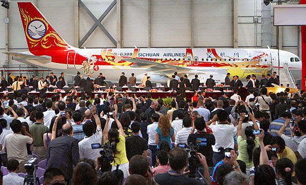 People take pictures of the first China-assembled Airbus A320 jet on display at the Airbus Tianjin plant in Tianjin municipality June 23, 2009. Airbus delivered its first plane assembled outside Europe to its Chinese owner on Tuesday, as the world's 