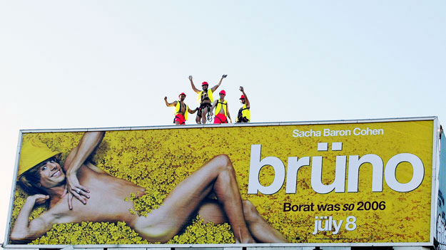 Brüno - Workers dressed in pink shorts and hard hats pose for photographers and TV crews after hanging a large outdoor poster promoting Sacha Baron Cohen's new film 