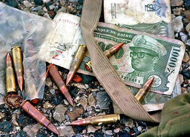 BULLETS FROM SOVIET MADE MACHINE GUN LAY ON ZAIRAN BANK NOTES FEATURING
MOBUTU SESE SEKO.