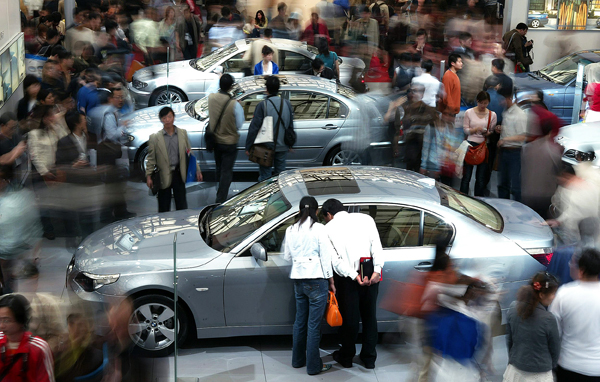 Chinese visitors view BMW cars at the 2005 Auto Shanghai Exhibition in China's financial capital April 23, 2005. Global car makers still see China as the promised land as growth stagnates in the developed world, but an escalating price war and rising