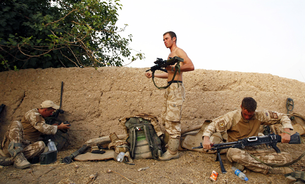 British soldiers from 3 SCOTS clean their rifles in a Taliban-held area of Afghanistan's Helmand province during Operation Panther's Claw, July 11, 2009. British troops have faced heavy fighting during the operation, a bid to clear out Taliban-held a