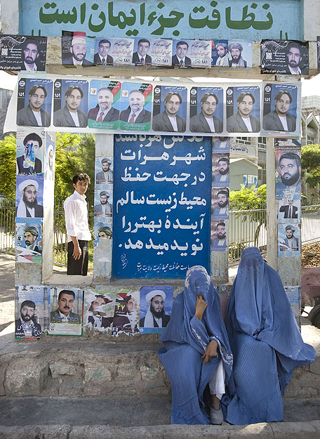 Afgán nők a nyugati Heratban az augusztus 20-i választások plakátja előtt