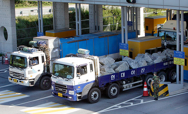 South Korean cargo trucks heading to the inter-Korean industrial complex in Kaesong, North Korea, depart the Customs, Immigration and Quarantine office, just south of the demilitarized zone separating the two Koreas, in Paju, about 45 km (28 miles) n