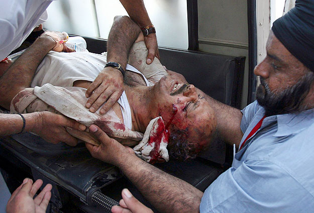A survivor of a bus accident is rushed to a hospital in Jammu September 7, 2009. At least 18 people were killed and 26 others injured when a bus they were travelling in skidded off the road and fell into the river Chenab in Jammu and Kashmir's Doda d