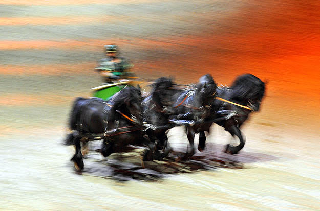 An actor and horses perform a scene from Ben Hur Live for the cameras during a preview from the show at the O2 arena, in east London September 15, 2009.  The touring show, which has it's world premiere on Tuesday,  marks the 50th anniversary of the C